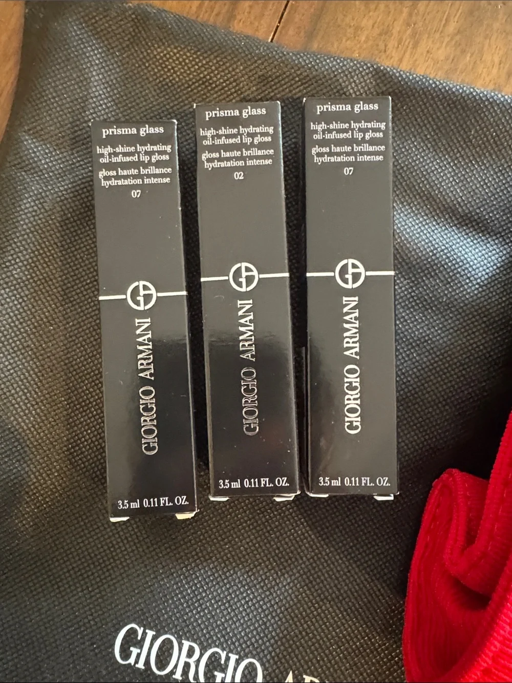 Giorgio Armani Beauty Bundle w/ Red Wristlet and three Armani Prisma Lip Glosses